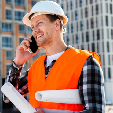 Professional construction contractor holding plans on site in Los Angeles by Trusted Contractor LA